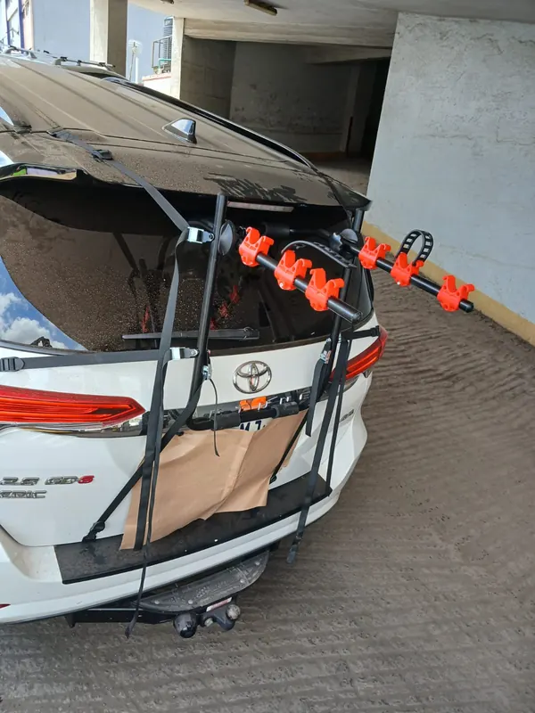 Bike carrier fitted to the back of a white car