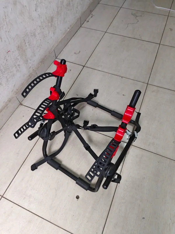 Bike carrier on the floor, showing its steel frame, padded arms and straps