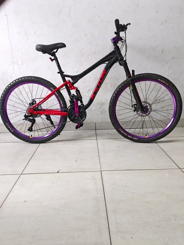 Kston mountain bike from the side, showing the middle suspension and disc brakes
