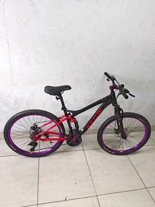 Kston mountain bike from the side against a white wall