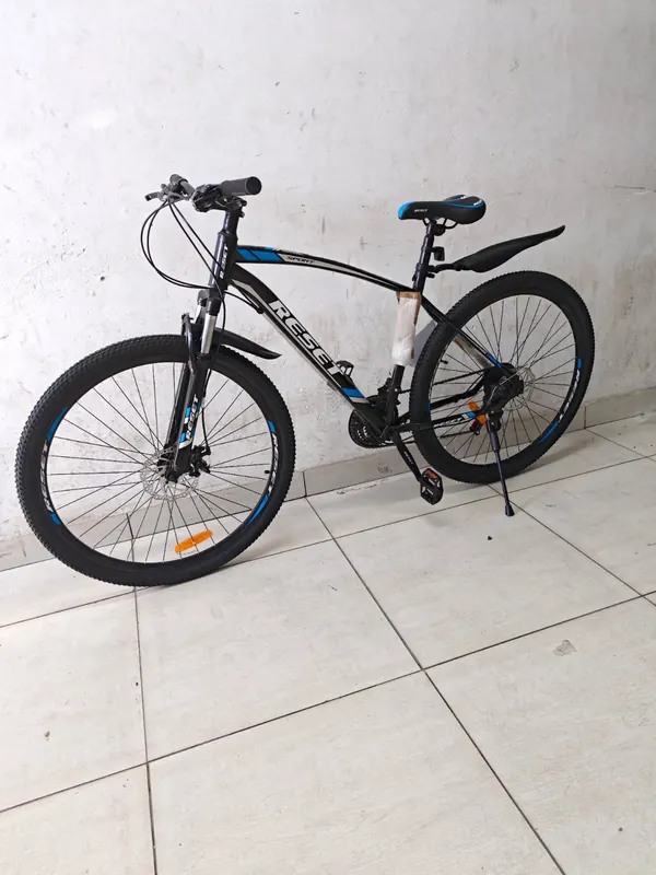 Reset 29-inch mountain bike in black and blue, on its kickstand