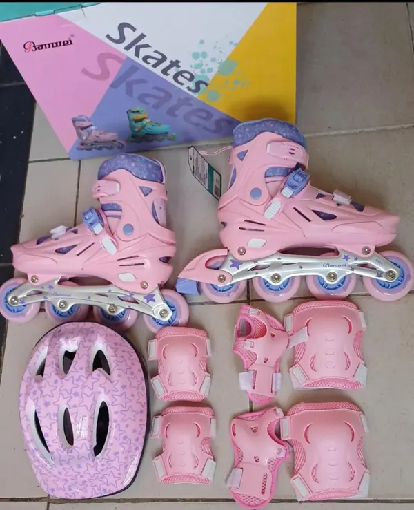 Pink rubber-wheel inline skates full set with helmet, knee, elbow and palm guards, beside its box