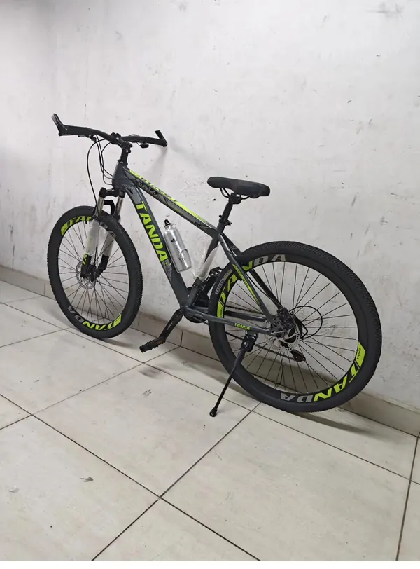 Tanda mountain bike seen at an angle from the front, showing the suspension fork and handlebars