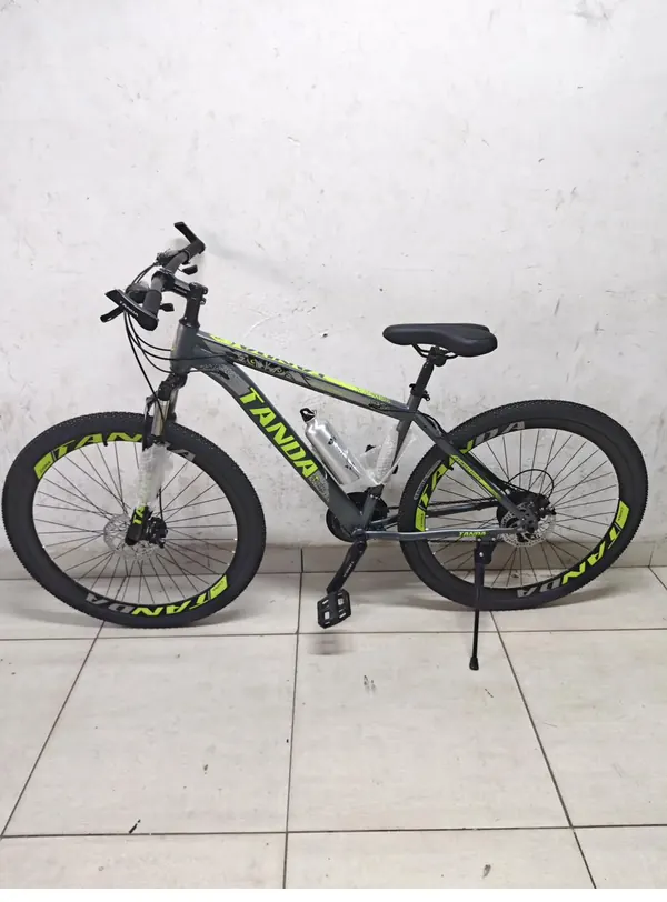 Tanda mountain bike from the side, standing on its kickstand