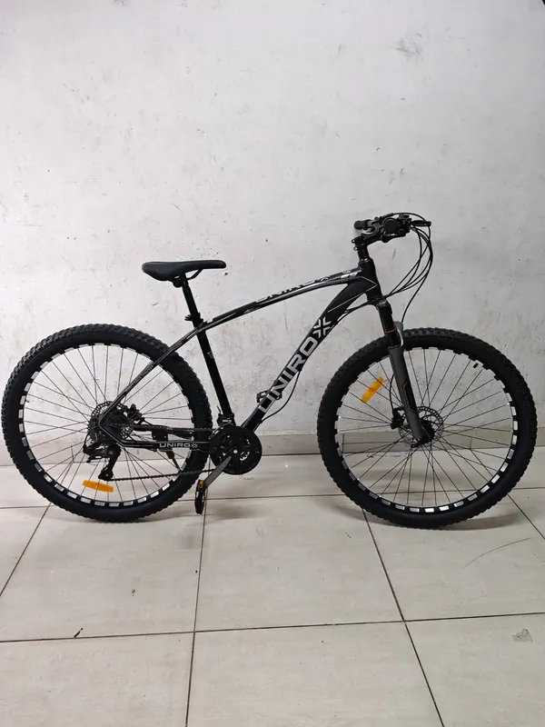 Unirox 29-inch mountain bike in black and grey, from the side