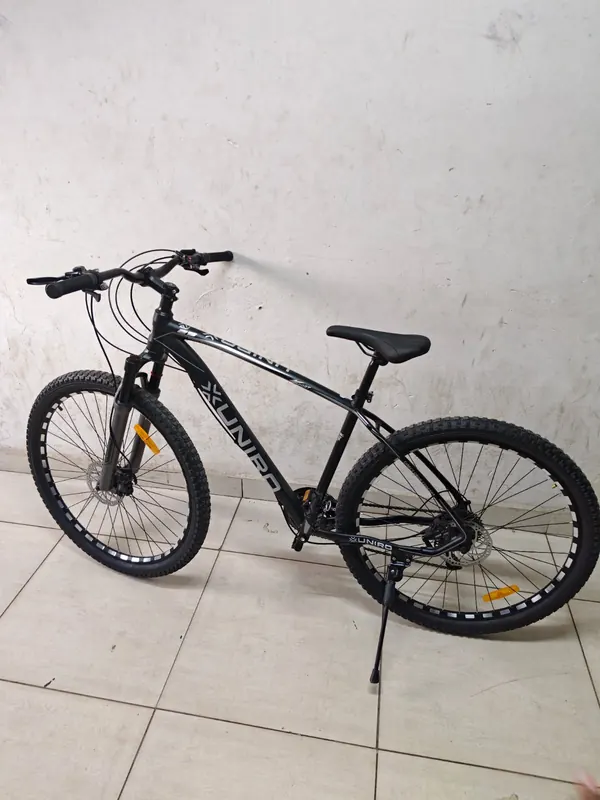 Unirox 29-inch mountain bike on its kickstand, facing left