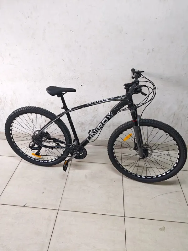 Unirox 29-inch mountain bike from the side against a white wall