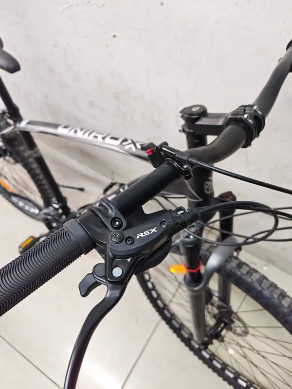 Handlebar of the Unirox 29-inch bike with its brake lever and shifter